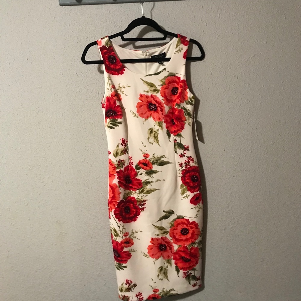 White dress with red flowers.